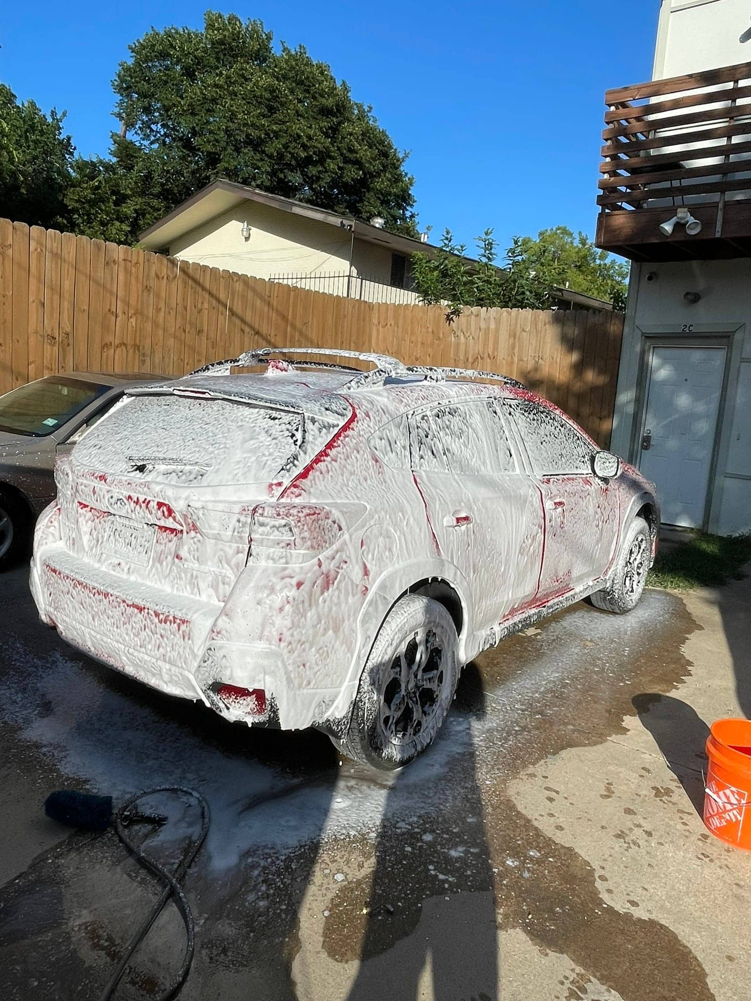 Professional mobile car detailing hand wash on red SUV in Dallas TX